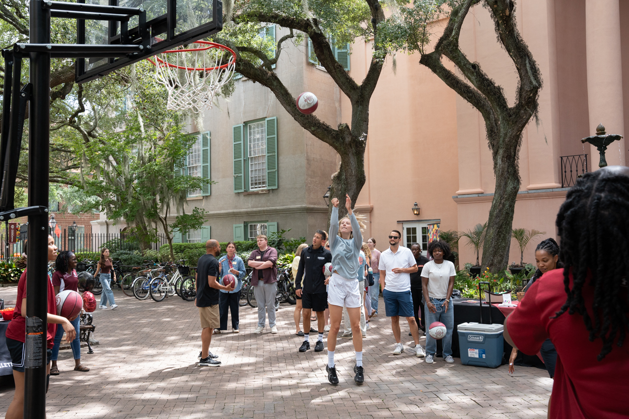 woman basketball player shoots hoops in cougar mall