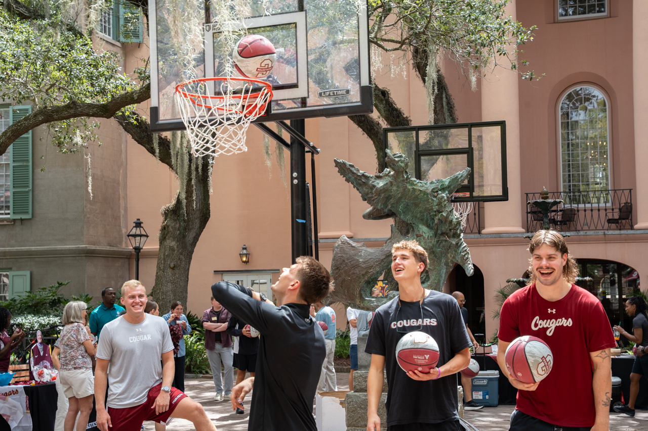 Mens Basketball team plays basketball outside in Cougar Mall