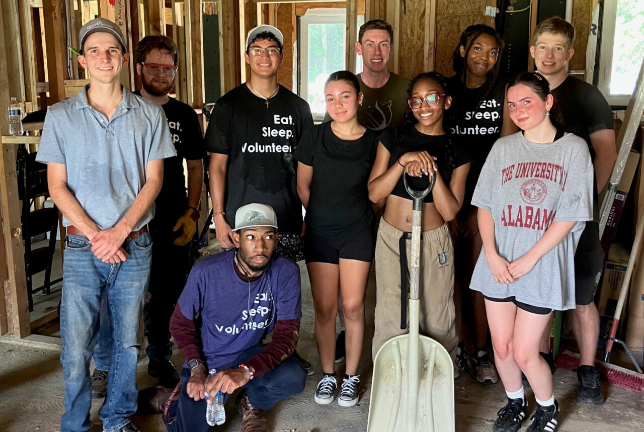 students pose together at build site